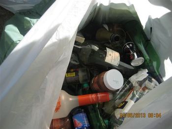 Steklena in druga embalaža odložena poleg zabojnika. (foto: Arhiv JP Snaga)